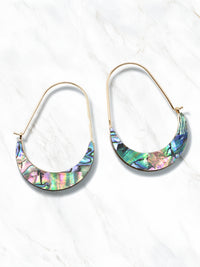 A pair of crescent-shaped hoop earrings featuring iridescent abalone shell inlays with vibrant shades of green, blue, purple, and pink. The earrings are set on delicate gold-tone wire hoops.