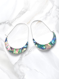 A pair of crescent-shaped hoop earrings featuring iridescent abalone shell inlays with vibrant shades of green, blue, purple, and pink. The earrings are set on delicate silver-tone wire hoops.