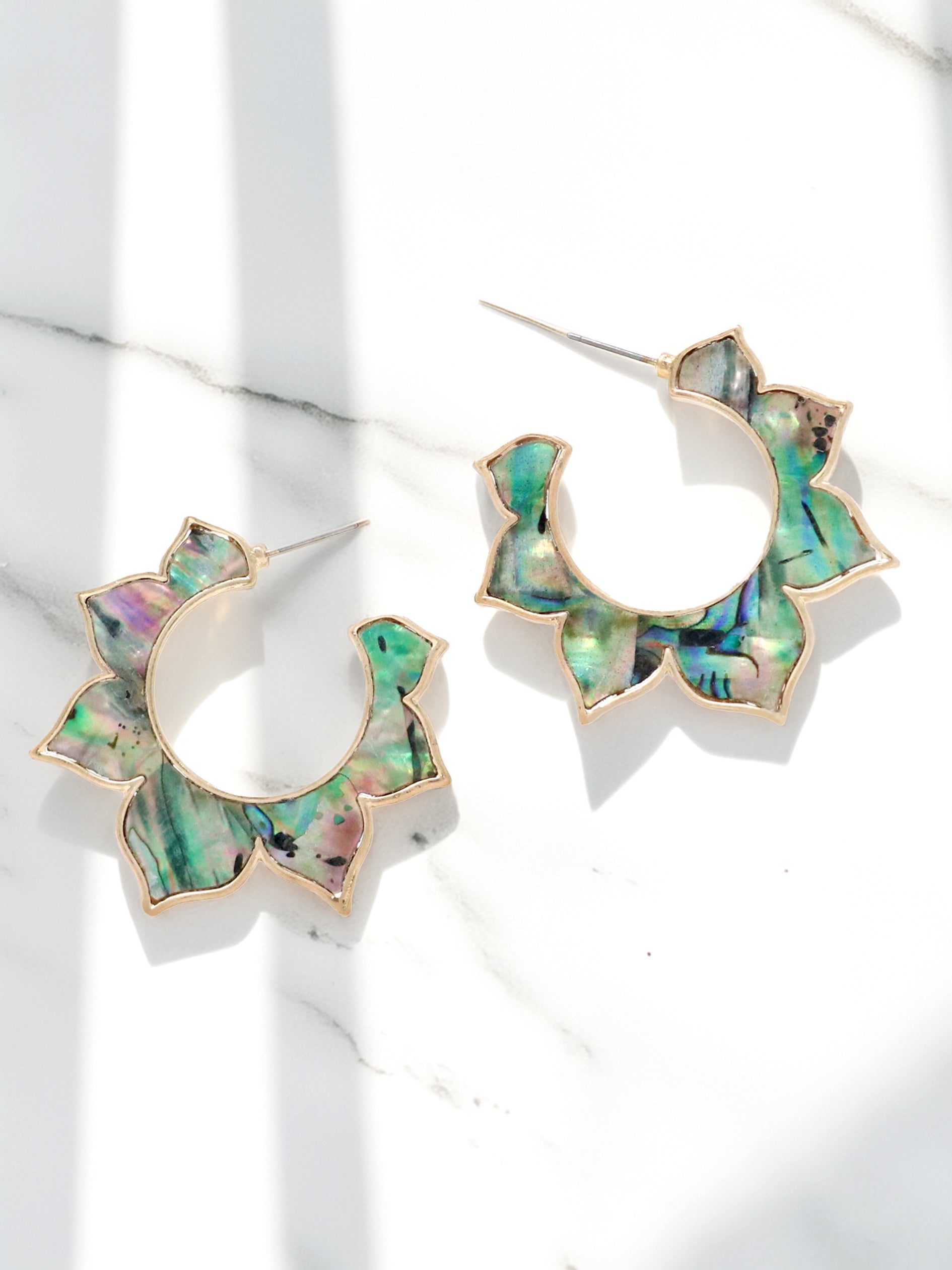 Floral shaped abalone shell hoop earrings.