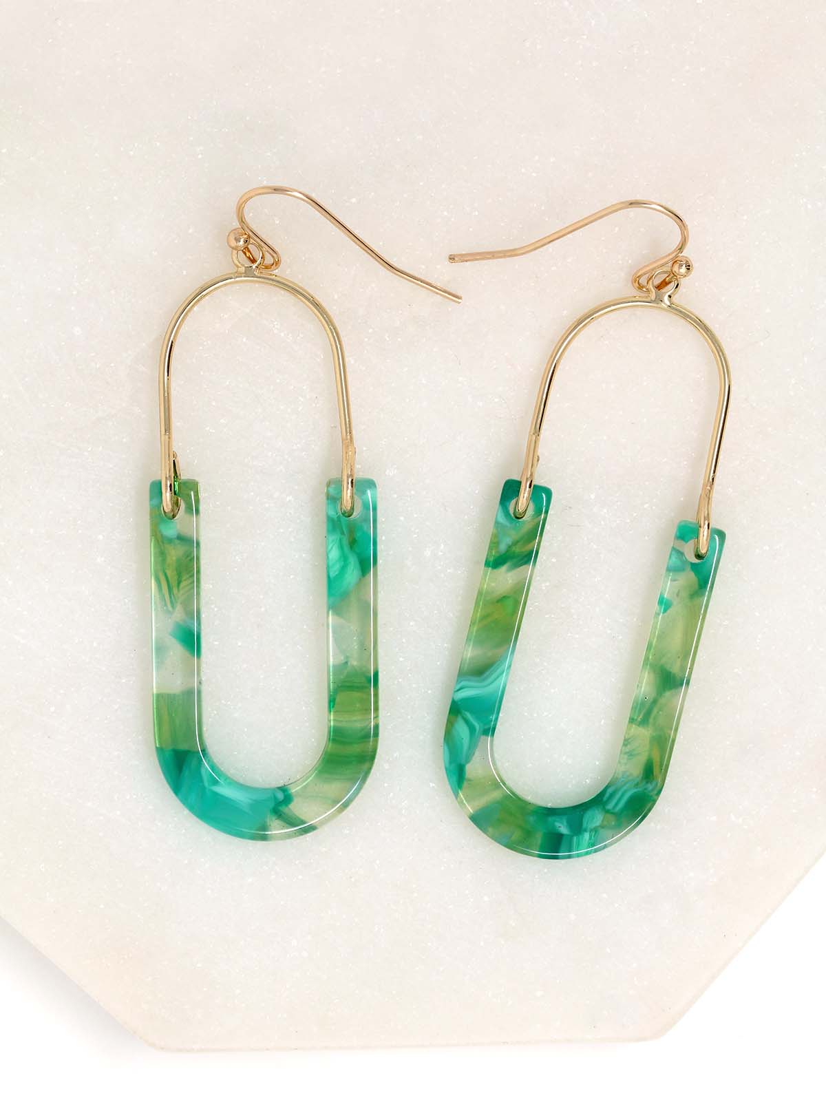 A pair of oval resin drop and dangle earrings with gold-tone hooks and frames. The U-shaped resin pendants feature a green tone.