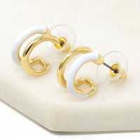 Double hoop earrings featuring white and metal hoops for a bold and stylish look.