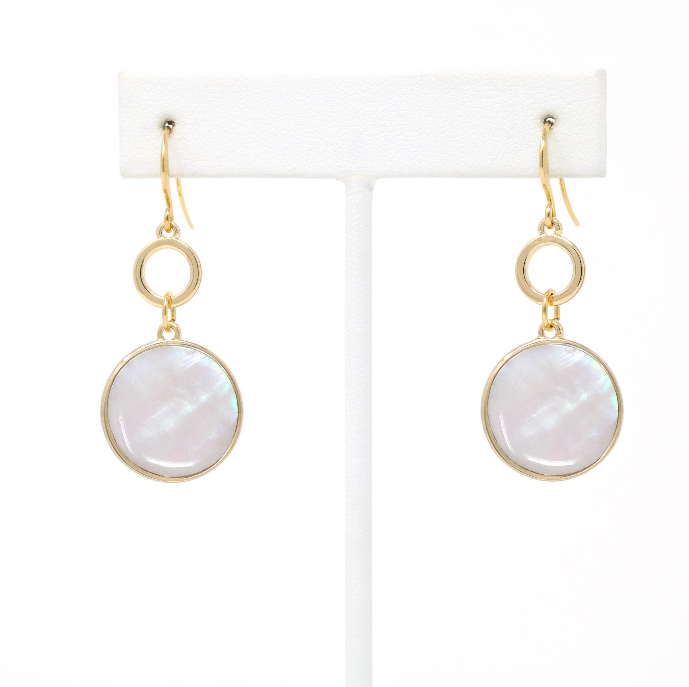 Gold-tone drop earrings with round mother of pearl shell inlays and circular link accents.