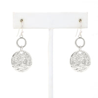 A pair of hammered charm drop and dangle earrings in silver.