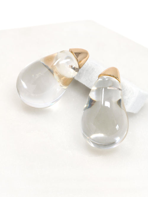 Clear lucite puffy teardrop earrings feature sleek and polished transparent resin teardrops that catch the light beautifully. 