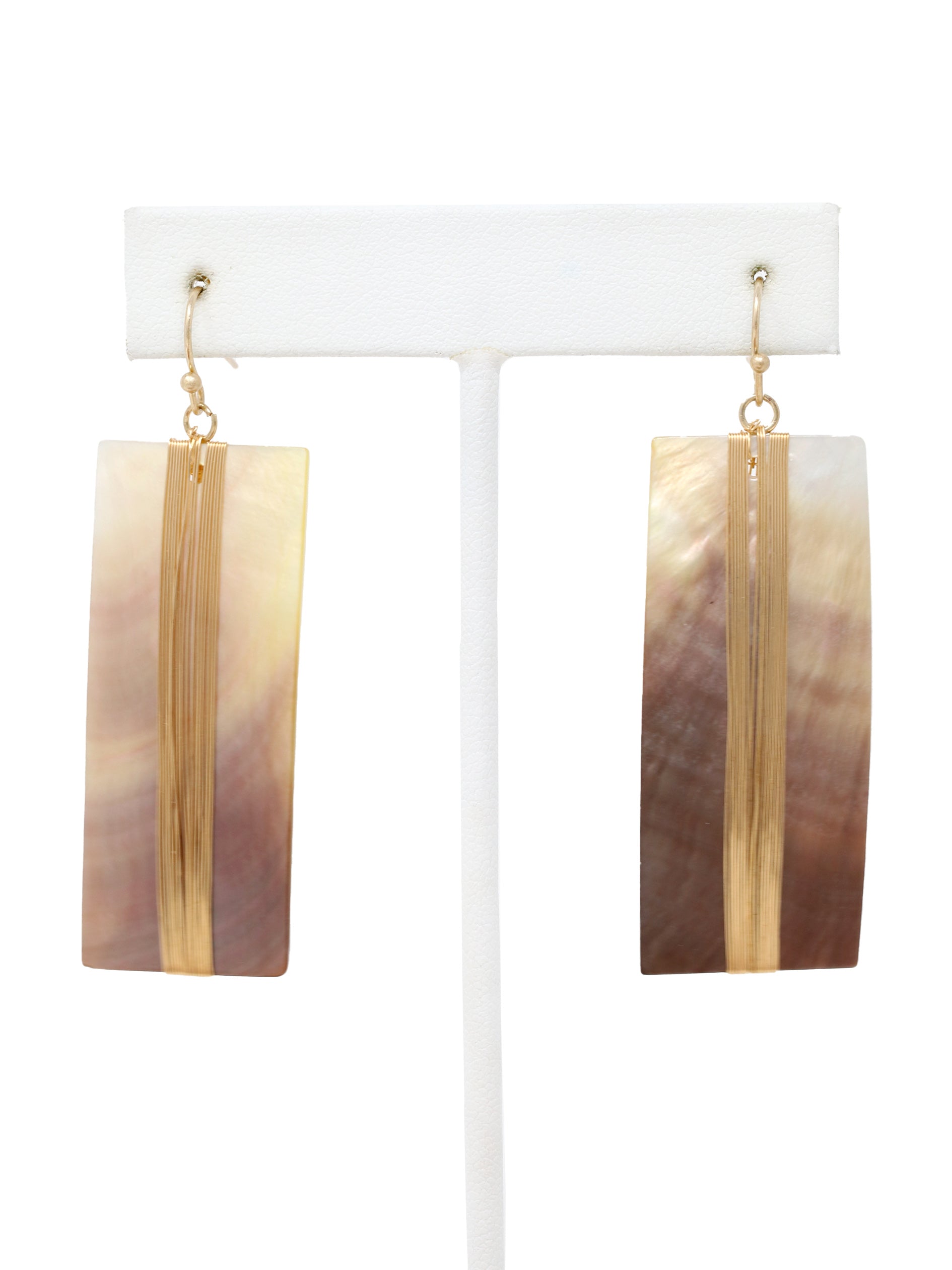 A pair of geometric statement earrings featuring natural mother of pearl shell with an iridescent finish, set in a sleek, modern design.