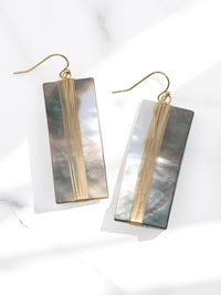 A pair of geometric statement earrings featuring natural mother of pearl shell with an iridescent finish, set in a sleek, modern design.