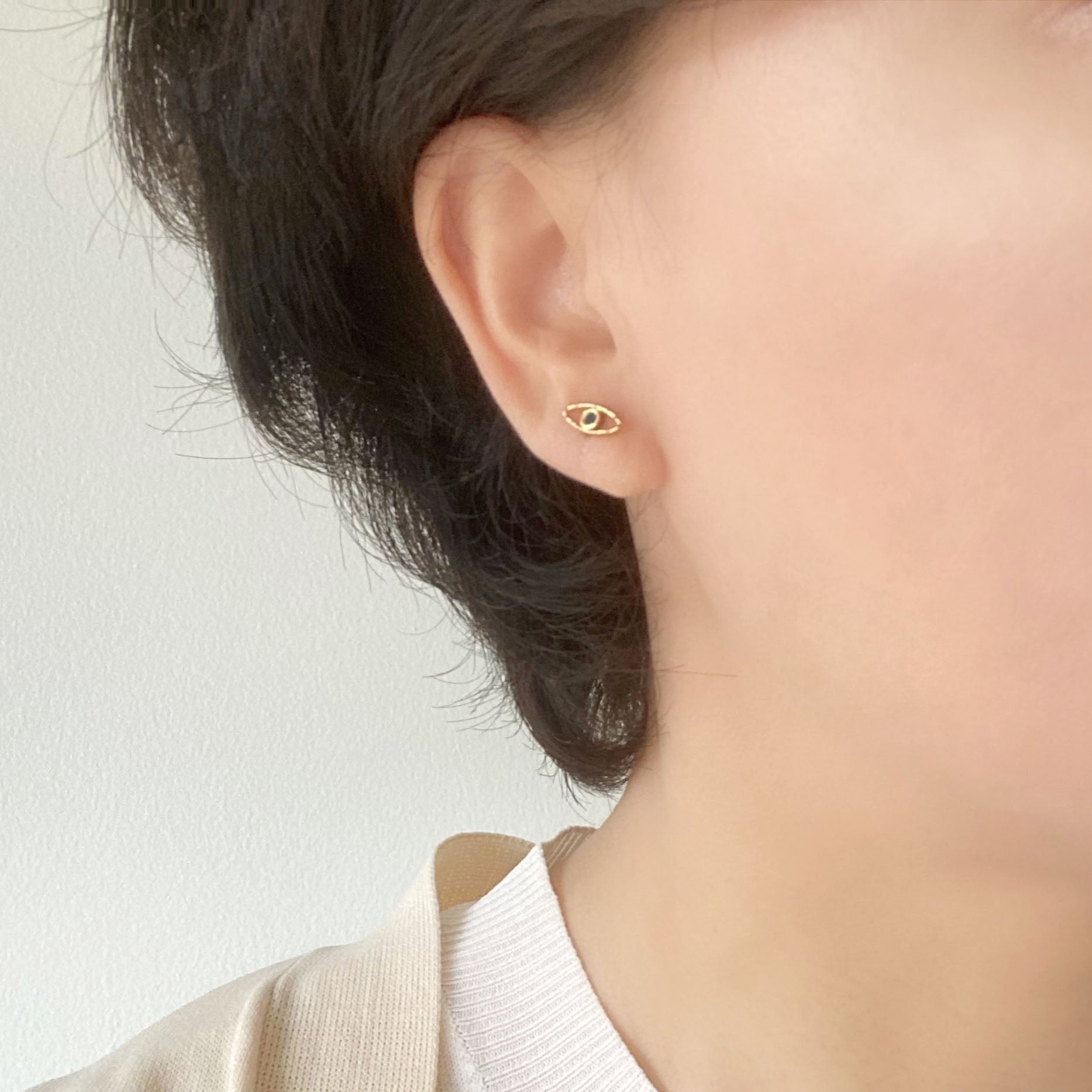 A pair of this  evil eye Earring is accent with a tiny blue zircon CZ stone.