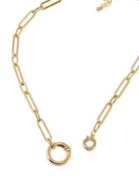 Gold paperclip chain necklace with elongated rectangular links and a circular carabiner lock pendant in the center.