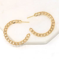 A pair of cuban chain textured hoop earrings made of gold filled.