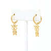 A pair of cute owl drop and dangle earrings in huggie hoop earrings made of gold filled.