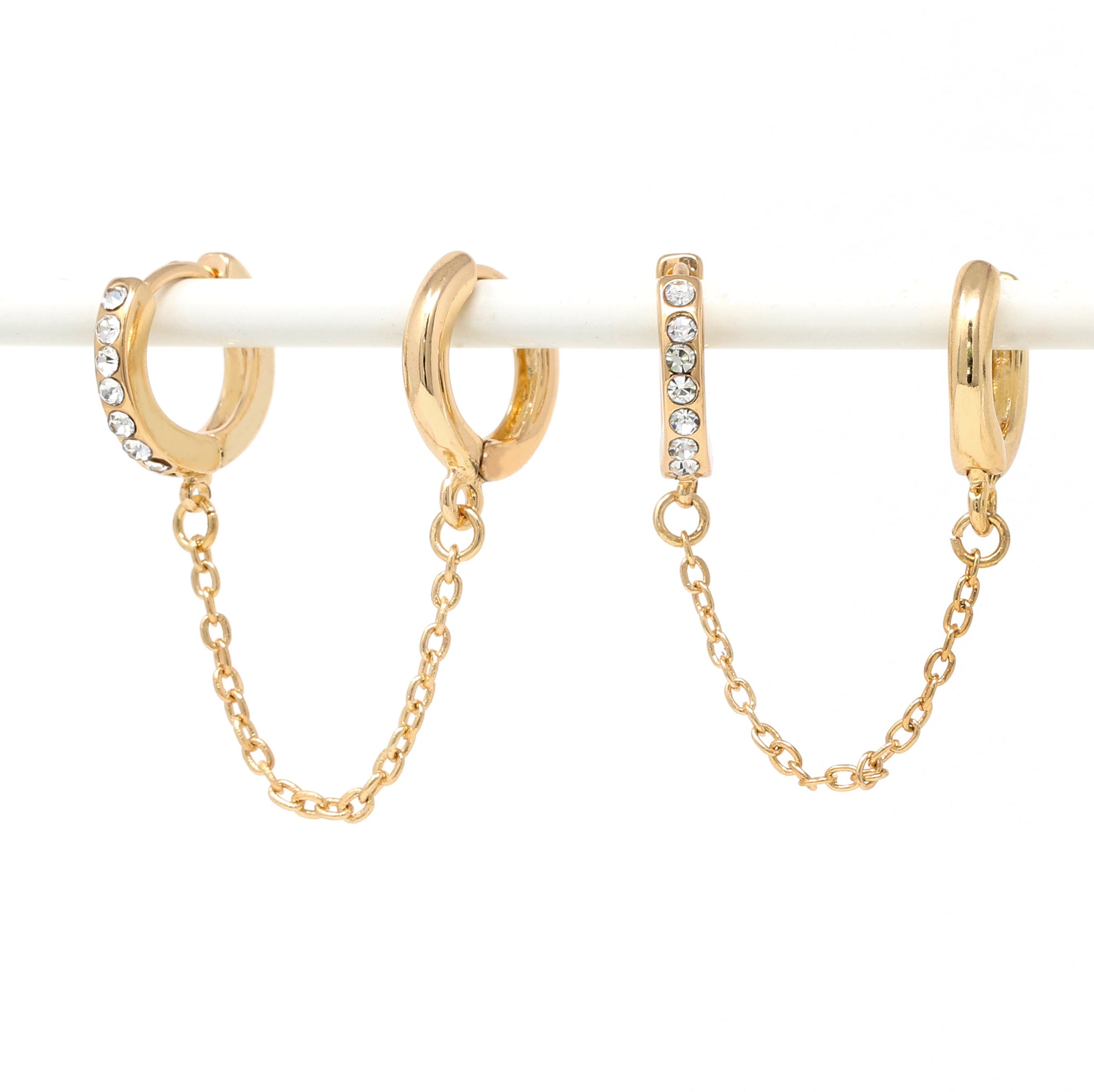 Paved modern loop earplug earrings in gold connected with chains.