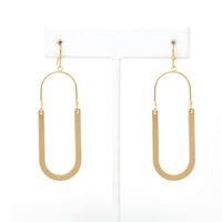 Oval shaped earrings featuring metal drops suspended from gold-plated hooks.