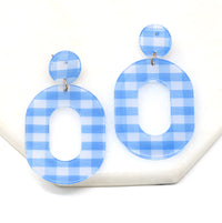 A pair of striped resin drop and dangle earrings in light blue color.