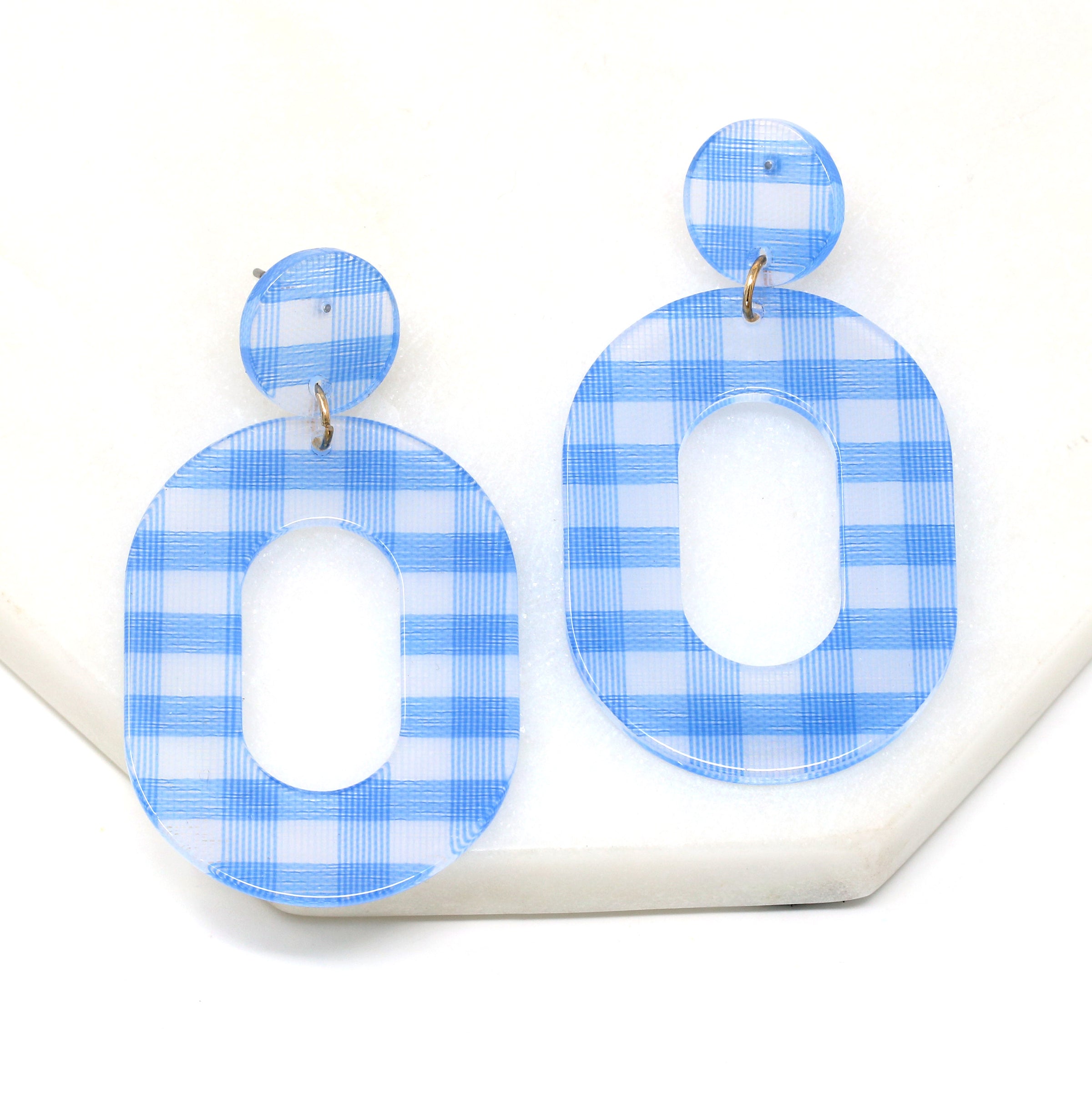 A pair of striped resin drop and dangle earrings in light blue color.
