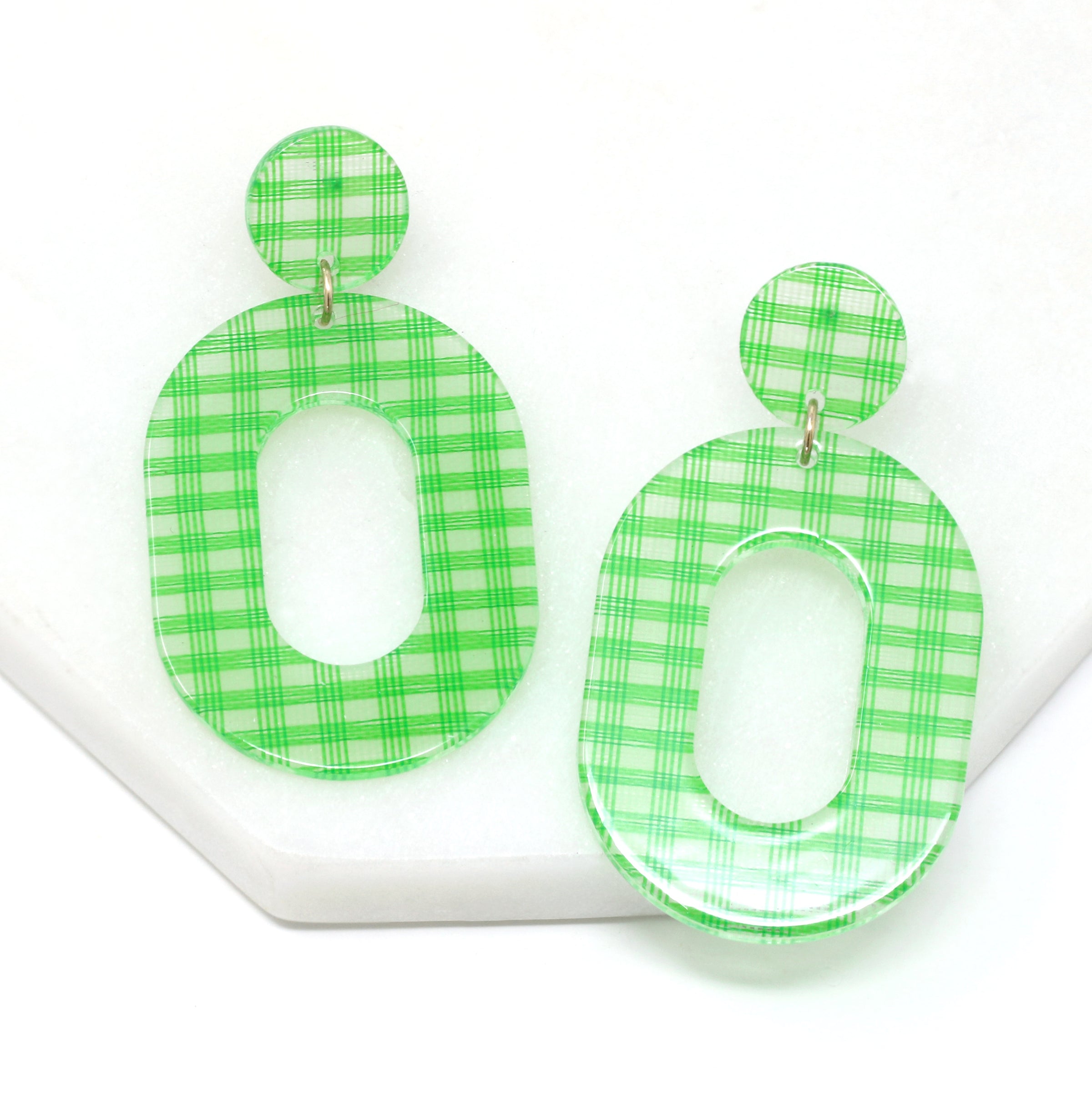 A pair of striped resin drop and dangle earrings in light green color.