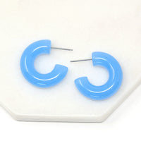 Featuring a pair of minimalist design bold resin hoop earrings crafted with high-quality tranquil blue resin material, adding a pop of color to any outfit.