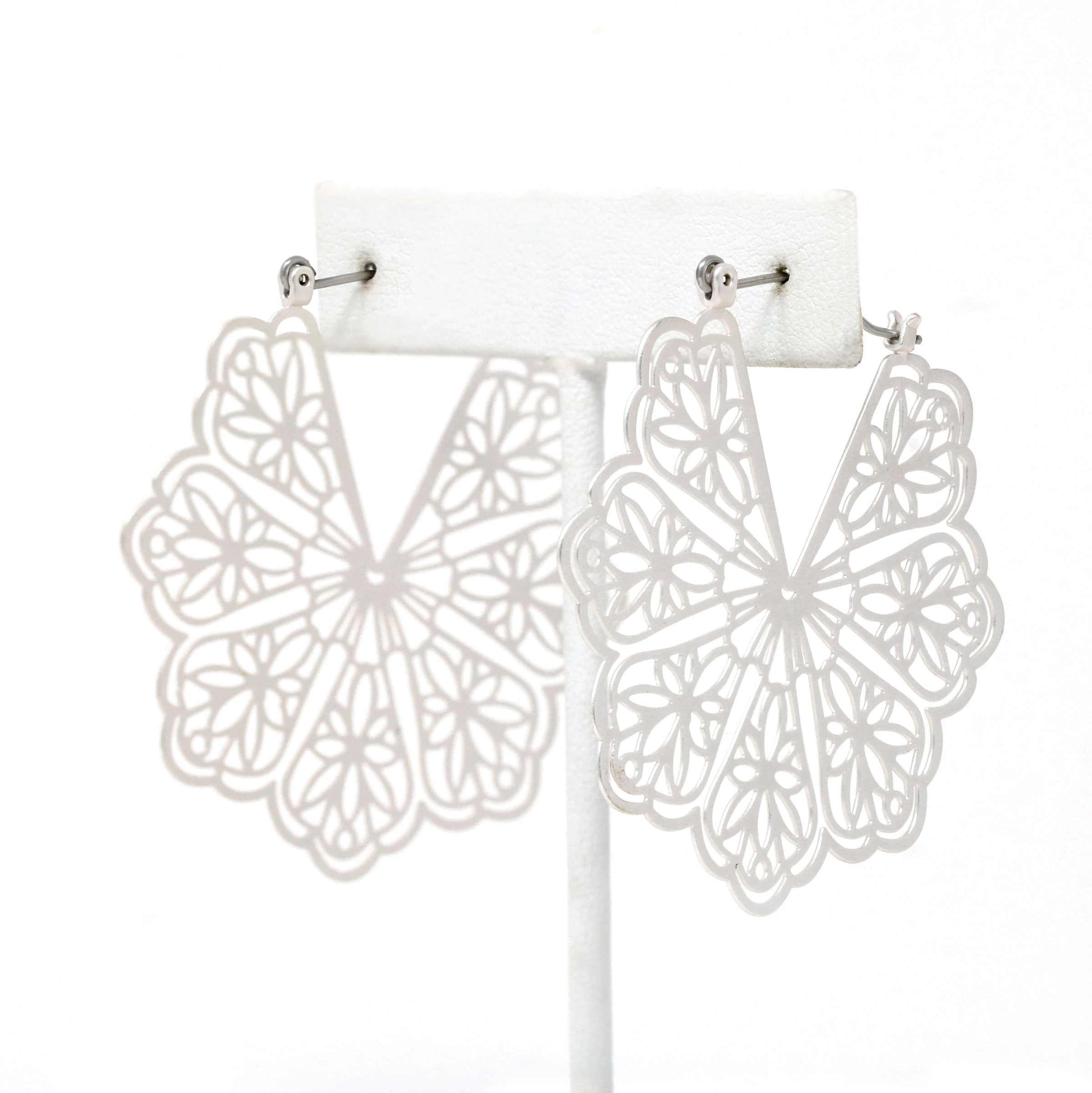 A pair of floral patterned filigree lightweight statement hoop earrings in silver.