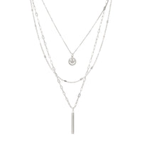 A set of triple layered necklace in silver with a small smiley face and a skinny bar charms.