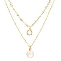 A set of double layer necklace in gold with a small disc and a gold trimmed mother of pearl charm.