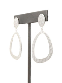 Pair of silver teardrop earrings on a gray earring stand against a white background