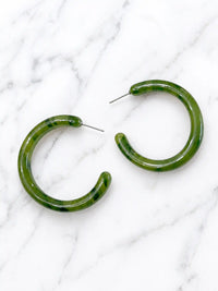 A pair of large, olive green toned hoop earrings made of mottled plastic.