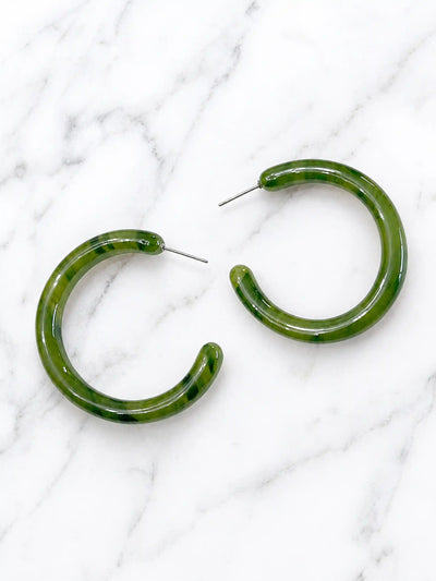 A pair of large, olive green toned hoop earrings made of mottled plastic.