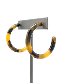 Brown tortoise resin hoop earrings with a marbled pattern of beige, brown, and black.
