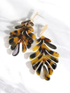 Tortoiseshell leaf-shaped earrings on a white background