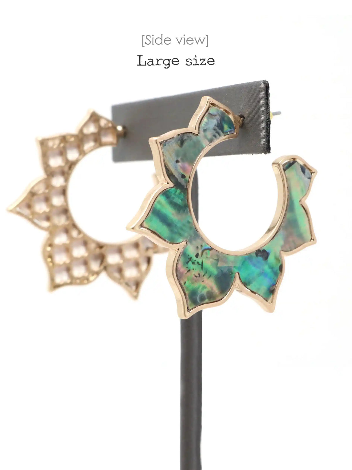 Side view of a pair of large gold-tone hoop earrings with iridescent green-blue abalone shell inlays, displayed on a black stand against a white background with text reading '[Side view] Large size'.