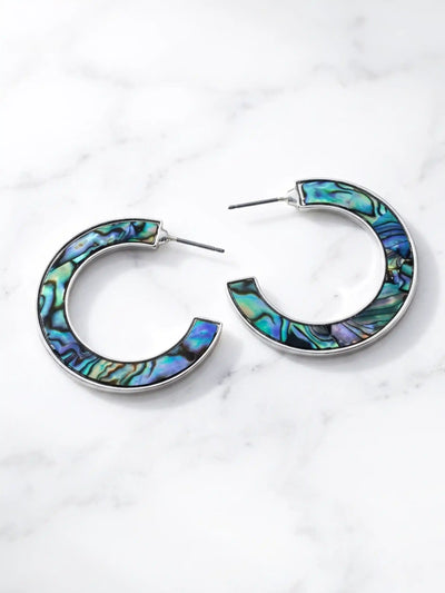 Natural abalone shell hoop earrings with iridescent blue, green, purple and black tones on silver hoops.