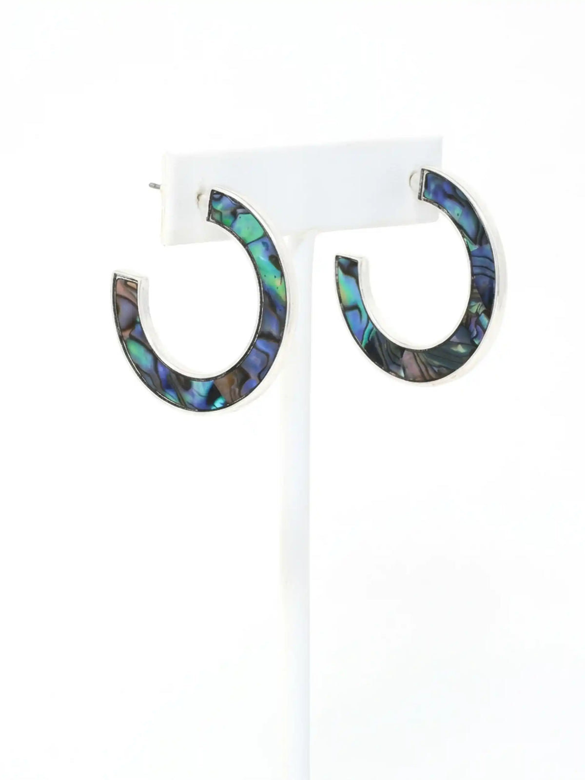 Natural abalone shell hoop earrings with iridescent blue, green, purple and black tones on silver hoops.