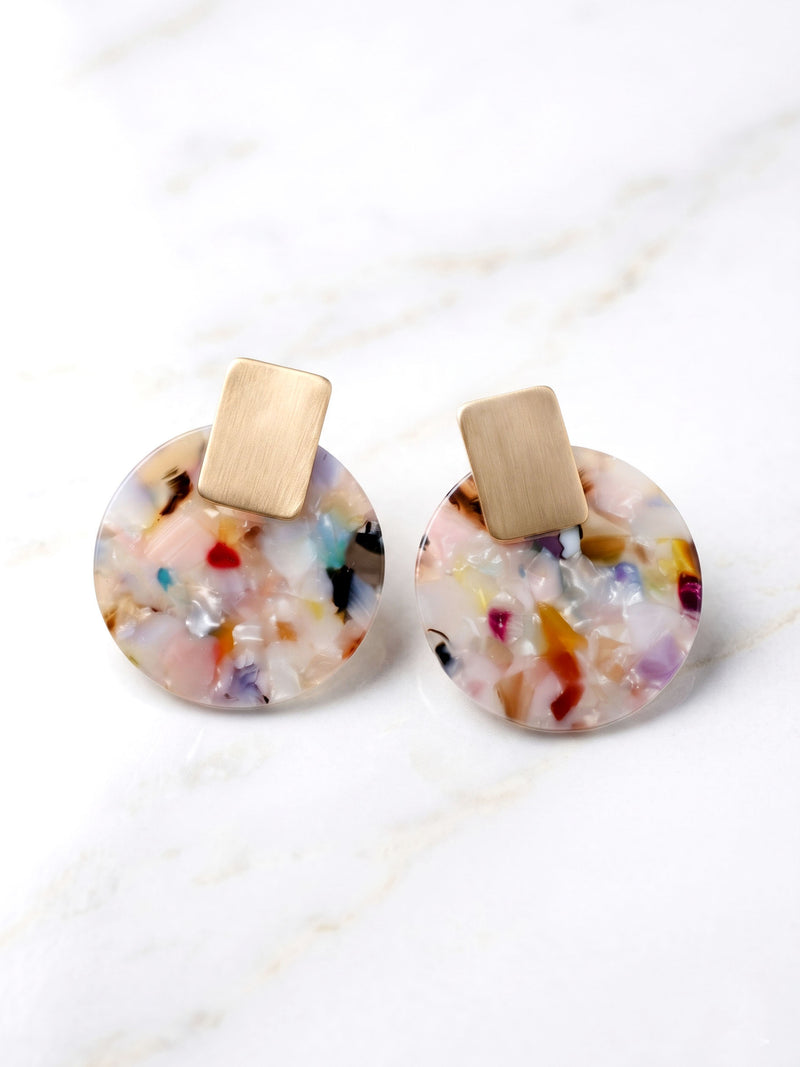 Colorful round earrings with gold posts on a white background
