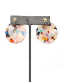 Multicolored round earrings on a gray earring stand with a white background