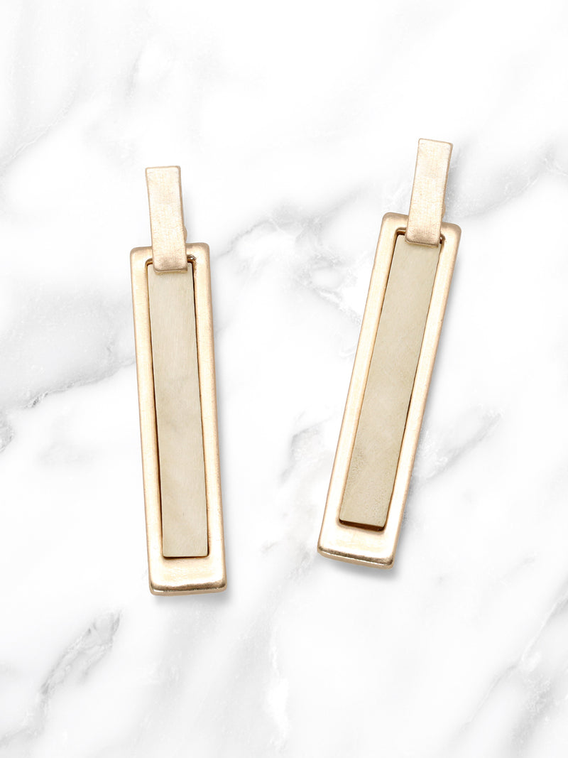 Gold bar earrings on a marble background
