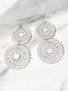 Silver beaded earrings on a marble surface