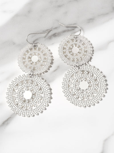Silver beaded earrings on a marble surface