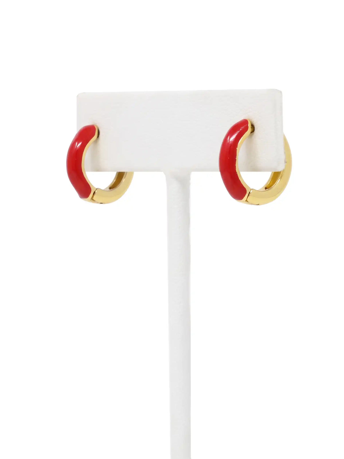 A pair of small gold-plated huggie hoop earrings featuring contrasting colorful red epoxy accents in a modern, compact design.