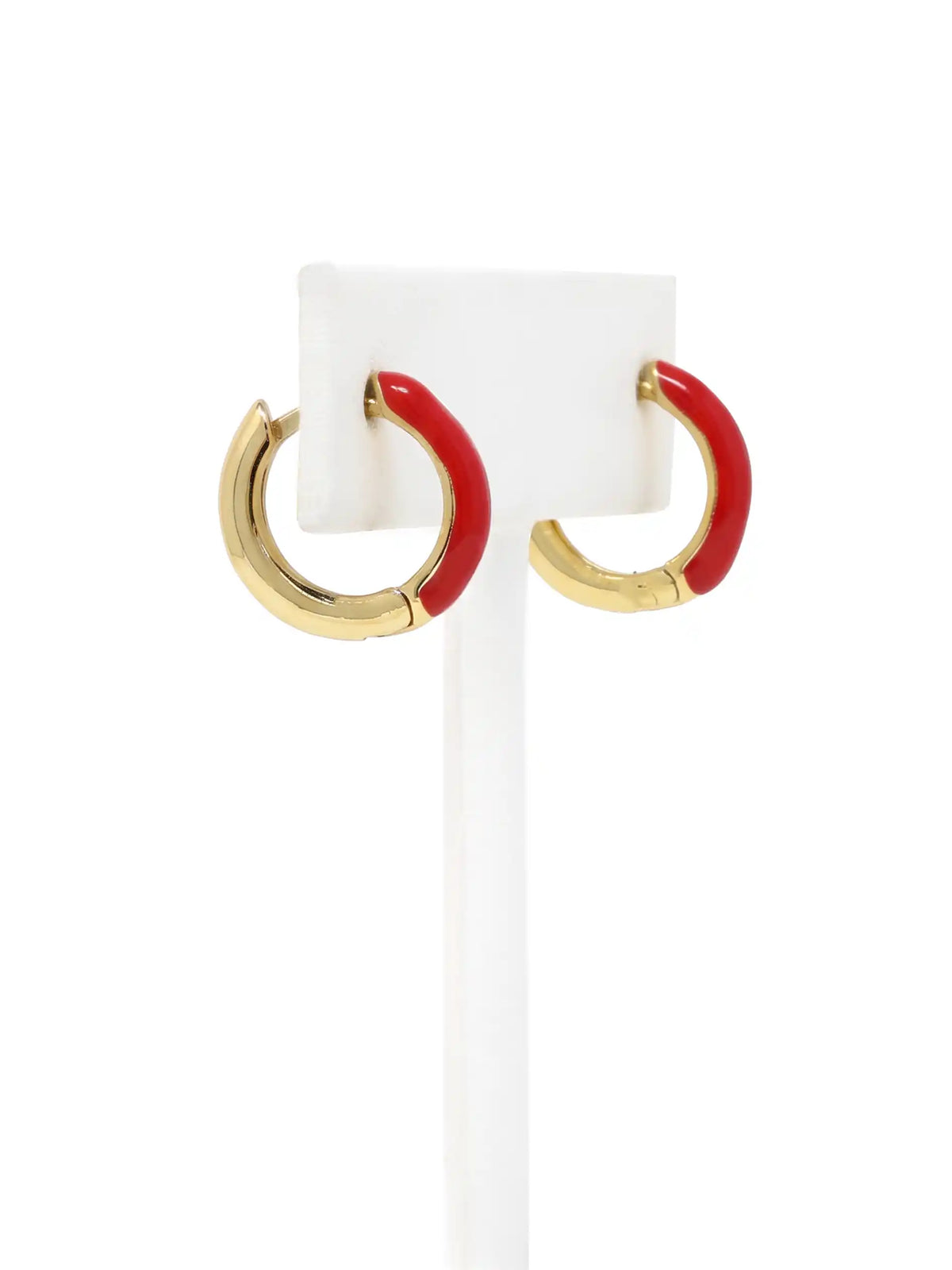 A pair of small gold-plated huggie hoop earrings featuring contrasting colorful red epoxy accents in a modern, compact design.