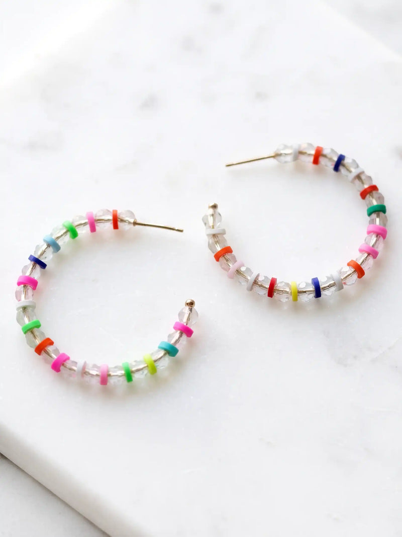 Lightweight clear glass beaded hoop earrings with multicolored rubber bead accents and gold-tone details by Bauble Sky.