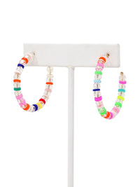 A pair of lightweight clear glass beaded hoop earrings with multicolored rubber bead accents and gold-tone details by Bauble Sky.