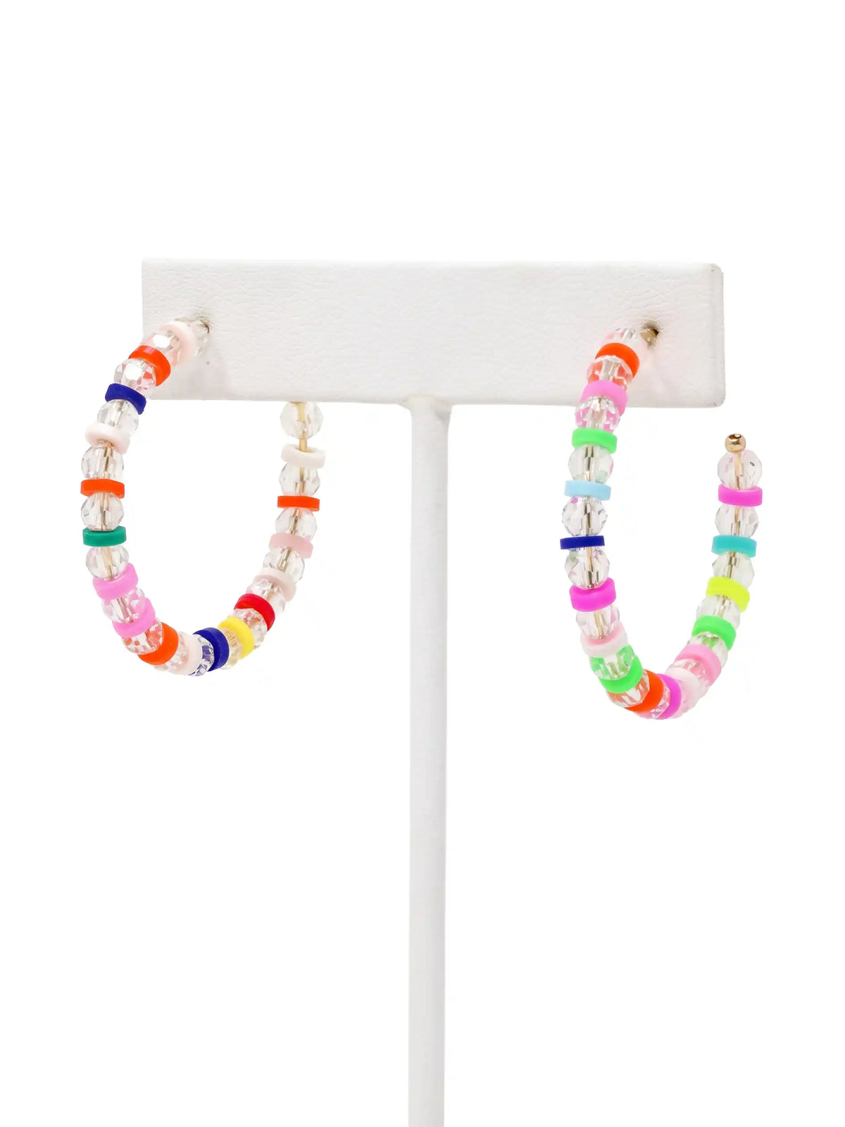 A pair of lightweight clear glass beaded hoop earrings with multicolored rubber bead accents and gold-tone details by Bauble Sky.