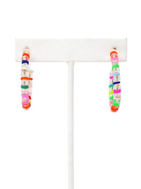 A pair of lightweight clear glass beaded hoop earrings with multicolored rubber bead accents and gold-tone details by Bauble Sky.