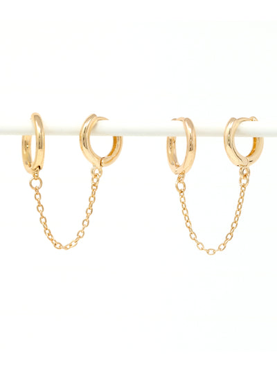 Gold hoop earrings with chains on a white background