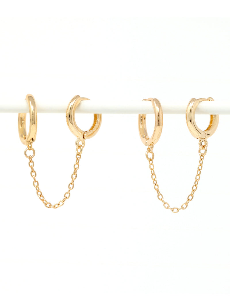 Gold hoop earrings with chains on a white background