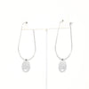 A pair of smiley face charmed teardrop hoop earrings in silver.