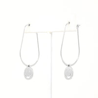 A pair of smiley face charmed teardrop hoop earrings in silver.