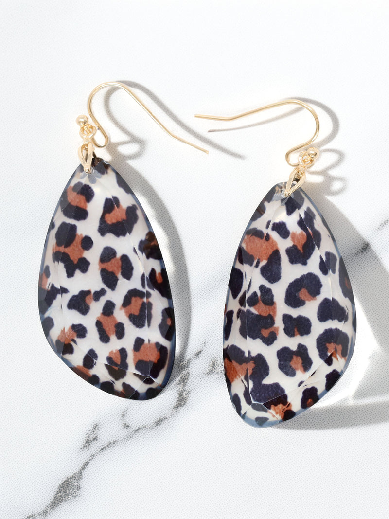 Leopard print earrings on a marble background