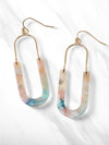 A pair of oval resin drop and dangle earrings with gold-tone hooks and frames. The U-shaped resin pendants feature a pastel multicolored, marbled design in soft pastel hues, including peach, blue, ivory, and peach.