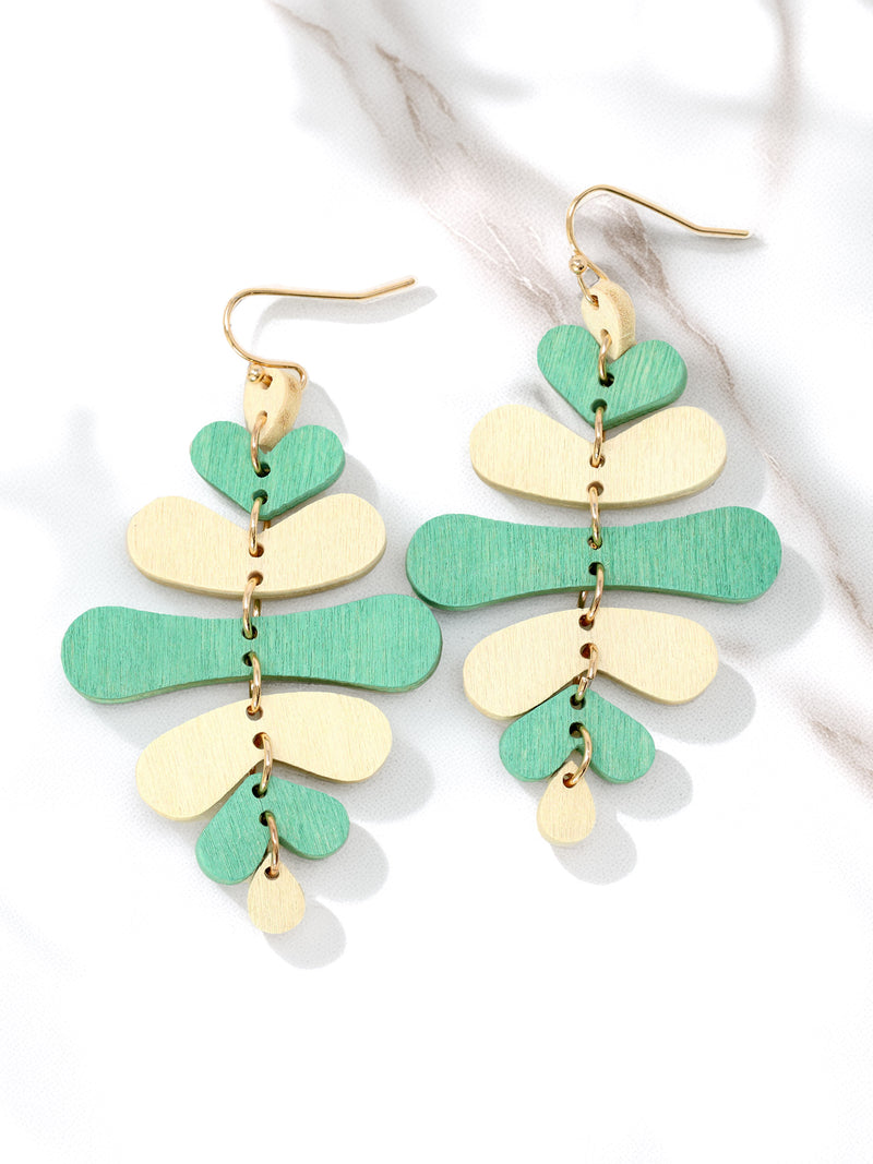 Pair of earrings with green and gold leaf-like shapes on a white background
