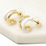 Double hoop earrings featuring white and metal hoops for a bold and stylish look.
